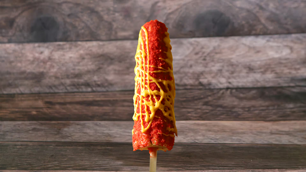 Corn on a stick topped with fresh cheese, margarine, mayonnaise, fresh lemon juice, and a spicy kick!