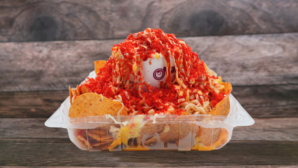 Ramen Esquite is a Mexican street food fusion of ramen noodles and esquites, topped with corn, mayo, cotija cheese, butter, lime, and chili powder.